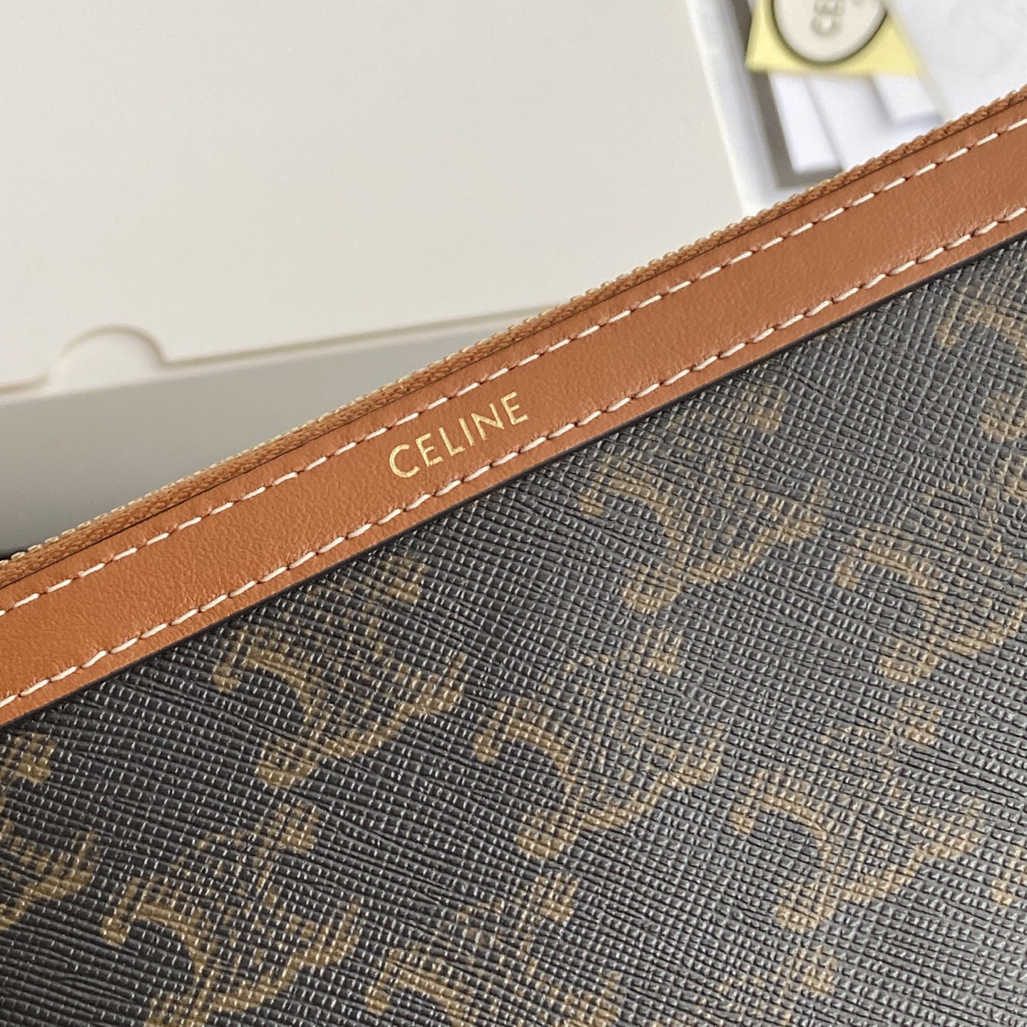 Ce**e long pouch with strap in triomphe canvas and calfskin 21.5x11.5x1cm